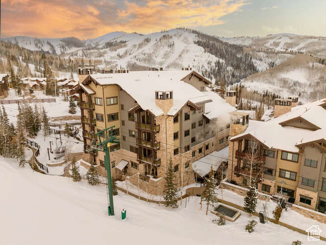 Snowy aerial view featuring a mountain view