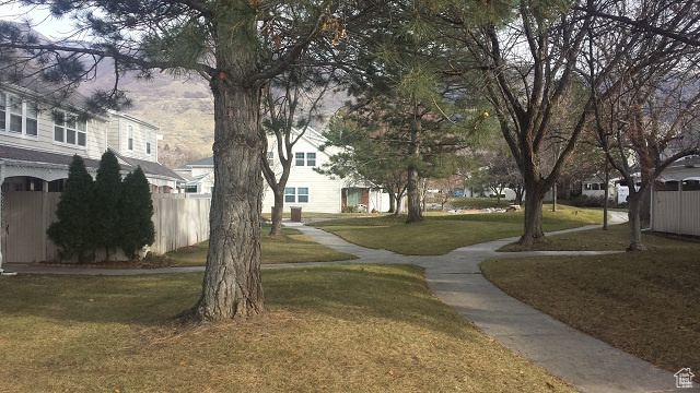 View of property's community with a lawn