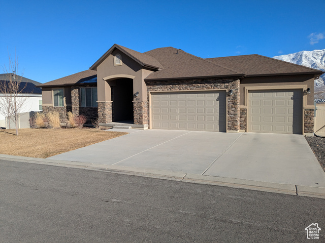 View of front of house featuring a mountain view and a garage