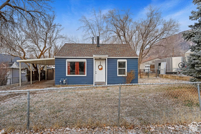 View of front of property with a carport