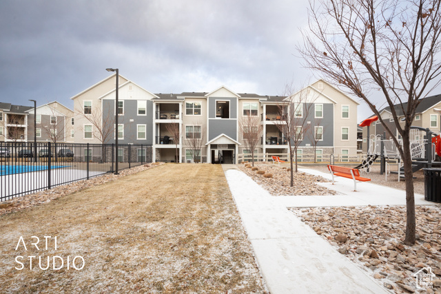 View of property's community featuring a playground and a swimming pool