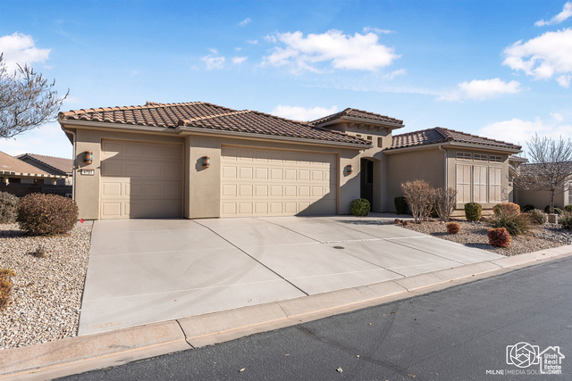 Mediterranean / spanish-style home featuring a garage