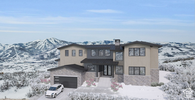 View of front of property with a garage and a mountain view