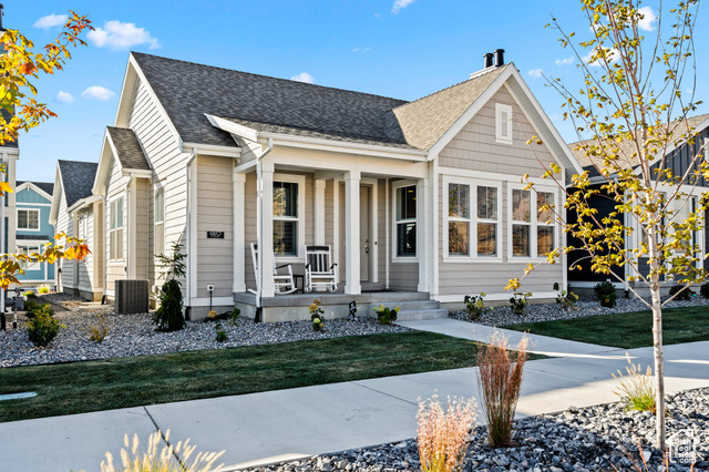 View of front of house featuring covered porch and a front lawn