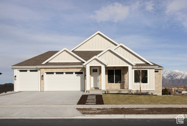 View of front of home with a garage and a mountain view