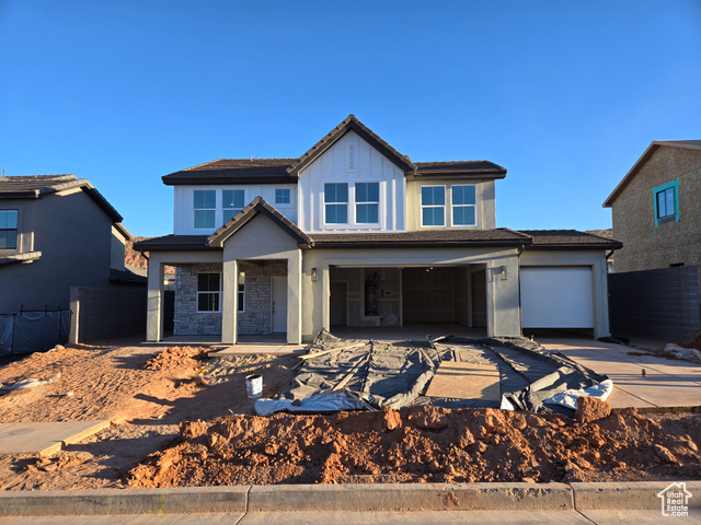 View of front of home featuring covered porch and a garage