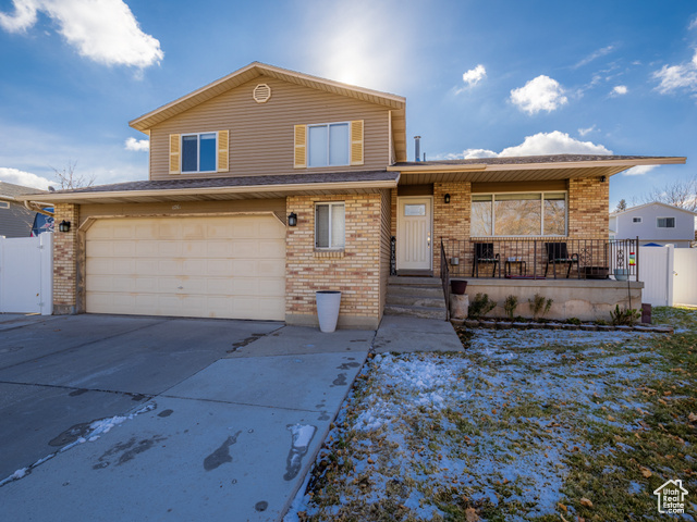 Front of property featuring covered porch and a garage