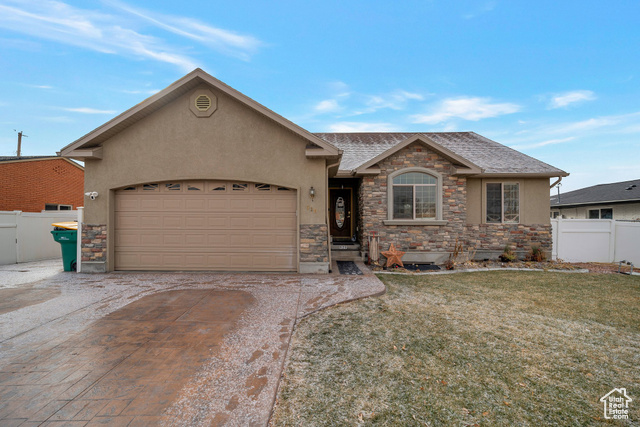 Single story home with a front lawn and a garage