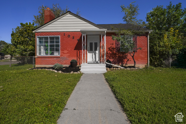 Bungalow-style home with a front lawn