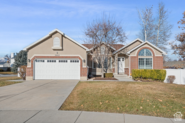 View of front of home with a garage and a front yard