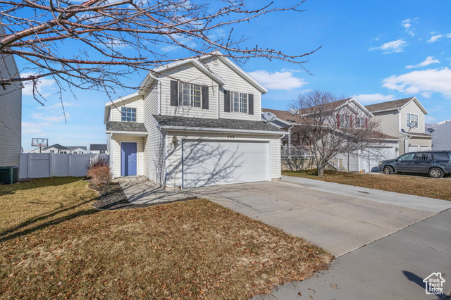 Front facade with a front yard and a garage