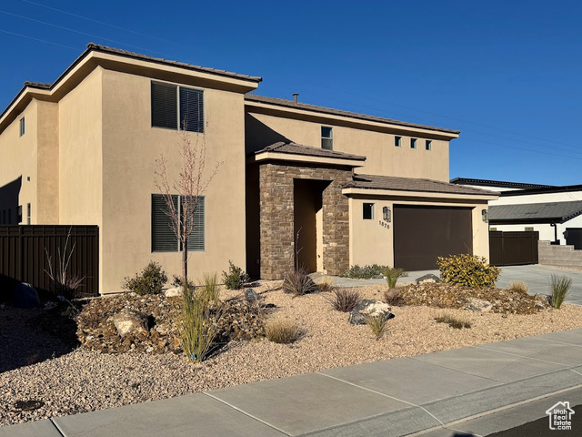 Prairie-style home featuring a garage and a carport