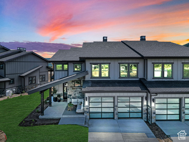 View of front of house featuring a lawn and a garage