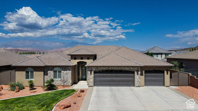 View of front of property with a garage and a mountain view