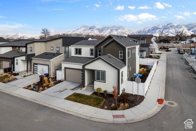 View of front of home with a garage and a mountain view