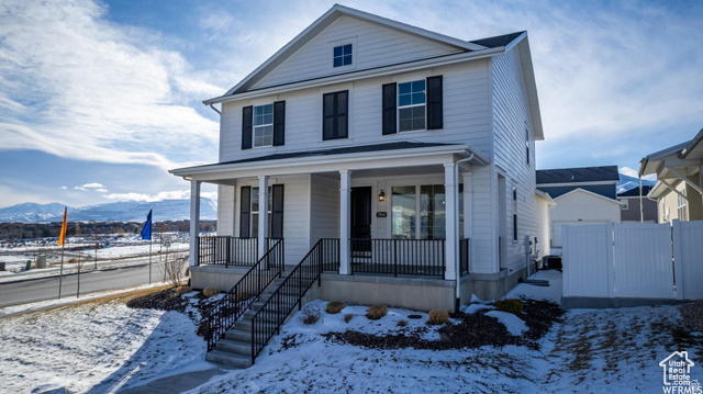 View of front property featuring a porch and a mountain view