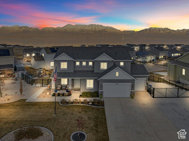 View of front of house with a yard and a mountain view