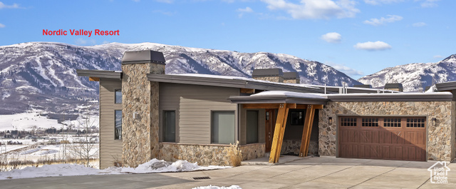 View of front facade featuring a mountain view and a garage