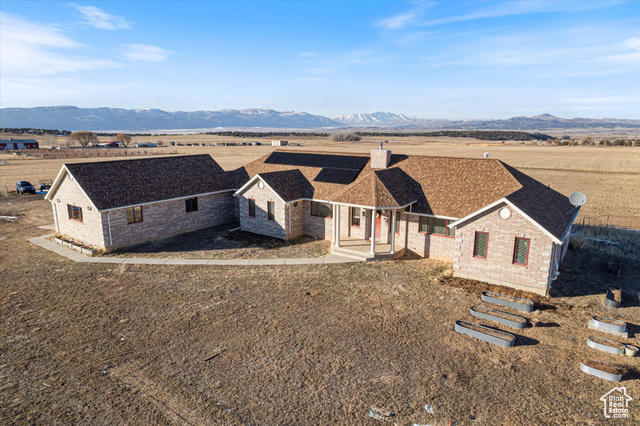 View of front of house with a patio area and a mountain view