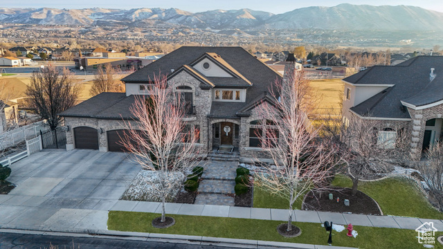 View of front of home with a garage and a mountain view