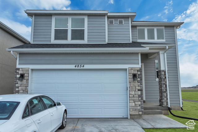 View of front facade featuring a garage