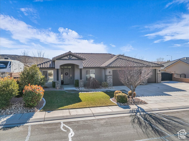 View of front of house featuring a front lawn and a garage