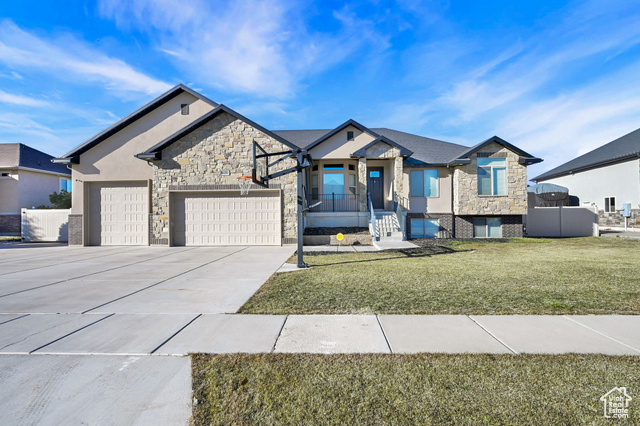 View of front facade with a front yard and a garage