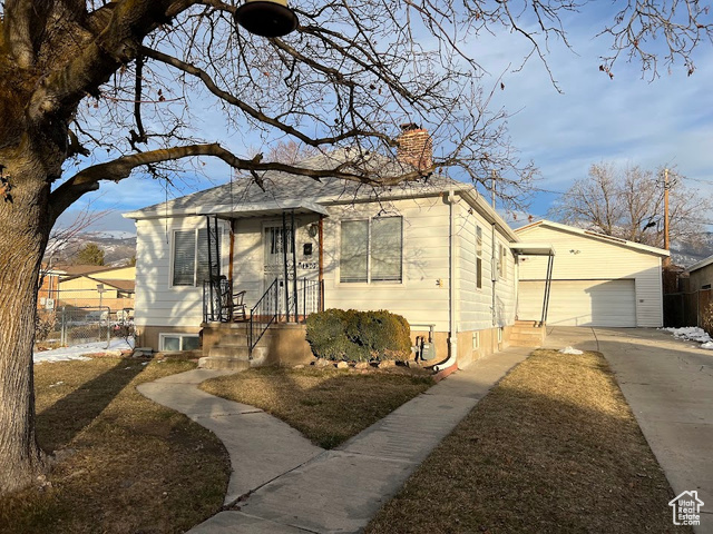 Bungalow-style house featuring a garage