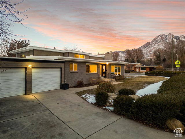 View of front facade with a garage and a mountain view