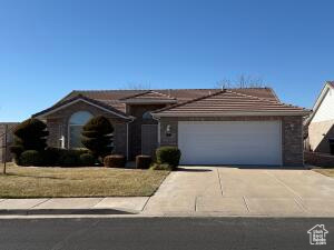 Ranch-style house with a front yard and a garage