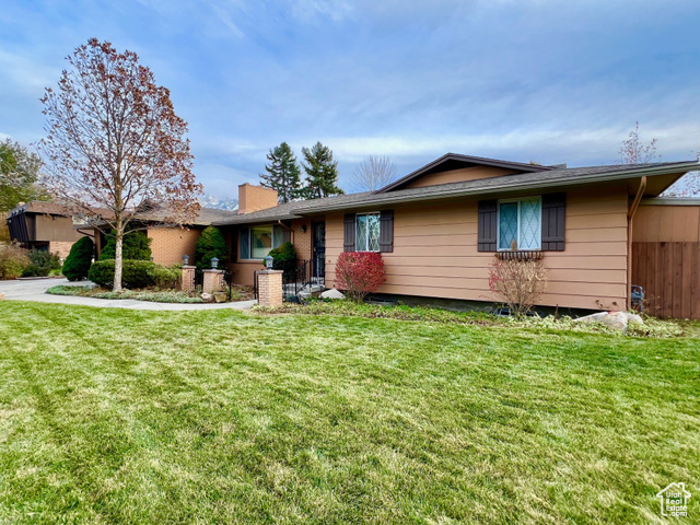 Ranch-style home with a front lawn