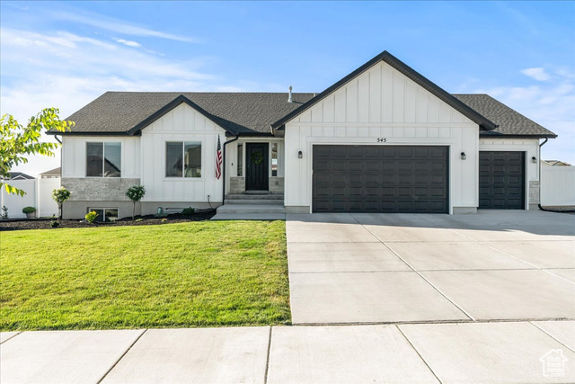 Modern farmhouse with a garage and a front yard