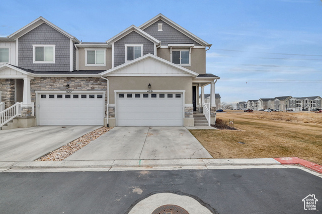 This beautifully upgraded end-unit townhome enjoys a prime location within the Vineyard community, situated on one of the best lots with direct access to lush open space. Inside, discover a welcoming ambiance with vaulted ceilings and a cozy fireplace. The upgraded kitchen features refined cabinetry, hardware, and backsplash, complemented by hardwood floors and quartz countertops. The spacious primary suite offers an upgraded ensuite with premium fixtures, while a modern powder-coated flat bar rail stairway adds a stylish touch. Additional features include upgraded lighting, plush carpeting, a high-efficiency tankless water heater, and an insulated garage provides added comfort and efficiency. The finished basement adds even more to the home's appeal, offering a fourth bedroom, bathroom, and a spacious family room-ideal for hosting guests or creating a cozy retreat. Resort-style amenities within the community, include a clubhouse, pool, pickleball and basketball courts, a playground, and picnic area. Perfectly situated for an active lifestyle, this home is near parks, trails, Sunset Beach, Topgolf, theaters, dining, Utah Valley University, and convenient transit options.  With its prime location, thoughtful upgrades, and exceptional community amenities, this home is the perfect blend of comfort, style, and convenience. Don't miss this incredible opportunity!