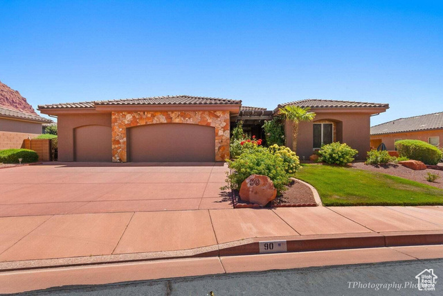 Mediterranean / spanish-style house with a garage