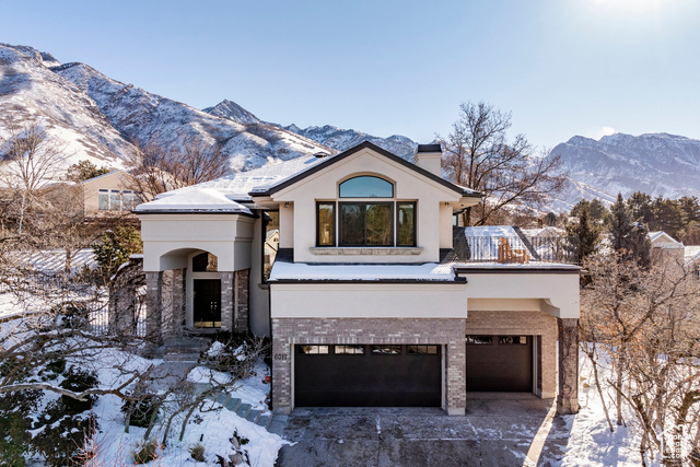 Nicely updated Cottonwood Heights two-story home. Located on Salt Lake's east bench on a quiet cul de sac with lovely views of the mountains and valley. Soaring two-story ceilings in the entryway and formal living room with two-story windows. Open kitchen and the great room are flooded with natural light and views from the large windows that frame the entire area. Nicely landscaped private yard with a large patio and pergola for summer barbecues and entertaining. An additional patio on the upper level provides lovely views of the valley and mountains. The upper level consists of four bedrooms, one of which is the large primary with beautiful views and a private deck, an additional bathroom, and laundry room. The lower level has an additional family room, two bedrooms, an exercise room and bathroom. A spacious three-car garage with extra storage is an added luxury. This beautiful property will not disappoint!