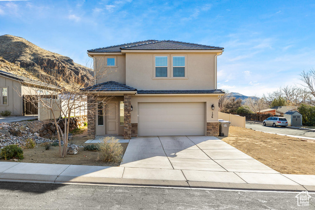 View of front property featuring a mountain view and a garage