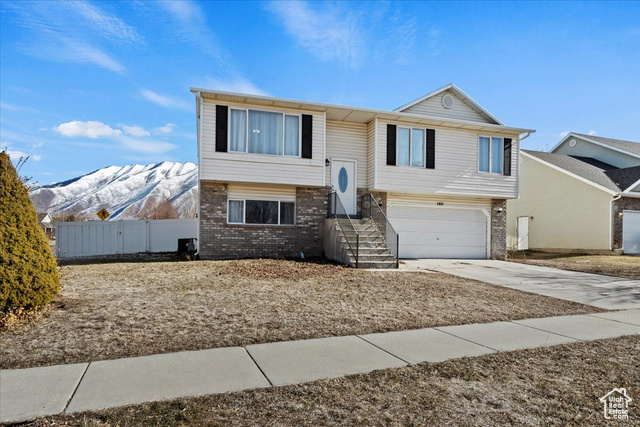 Step into this inviting split-level home on a picturesque corner lot in Spanish Fork, where comfort and convenience come together beautifully. With fresh paint and brand-new carpet throughout, this 4-bedroom, 3-bathroom home is ready to welcome its next chapter.  The moment you enter, you'll notice the light-filled living room and kitchen and the bright, cheerful atmosphere. The kitchen features a gas stove, a breakfast bar perfect for morning coffee, and sliding doors leading to the fully fenced backyard. Imagine entertaining friends or enjoying quiet evenings with mountain views as your backdrop.   The primary bedroom, complete with dual closets and an ensuite bath, invites relaxation with the extra deep tub. Adjacent you'll find two additional nicely sized bedrooms and another full bathroom, perfect for accommodating guests or creating personal spaces.  Downstairs, the daylight basement offers a second family room, a fourth bedroom, a third bathroom, and plenty of storage, making it ideal for whatever your lifestyle needs.  The location of this home is second to none. A short 10-minute drive brings you to I-15, Intermountain Hospital, Costco, Lowe's, and Hobby Lobby, while Walmart is just a 2-minute drive or 16-minute walk.   For added convenience, East Meadows Elementary is just a 4-minute walk away and Canyon Elementary is a 13-minute walk or a 2-minute drive. Directly across the street, you'll find Abbey Court Park Playground and Pavilion, perfect for outdoor activities and gatherings.  The sellers are including all major appliances and providing a one-year home warranty to ensure a smooth and worry-free transition. Combined with breathtaking mountain views and a prime location, this home offers the perfect blend of comfort and convenience.