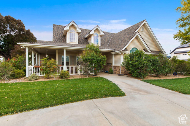 View of front of home featuring a porch and a front yard