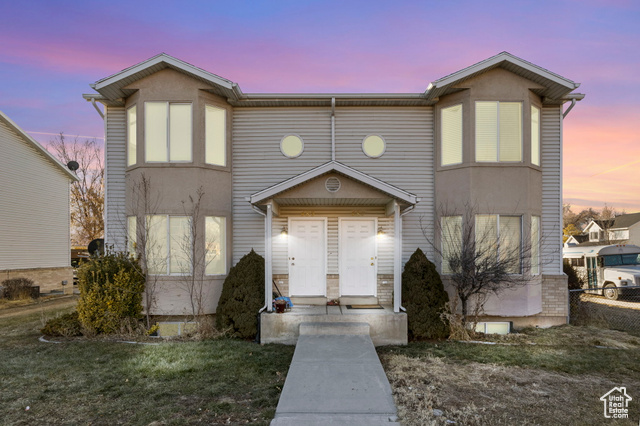 View of front of property with a yard