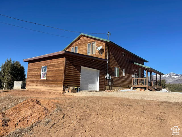 Exterior space with a garage and a mountain view