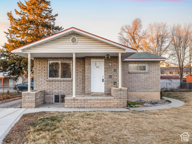 Bungalow-style home featuring a porch and a lawn