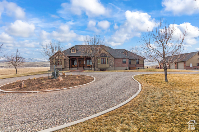 French country style house featuring a mountain view and a front lawn