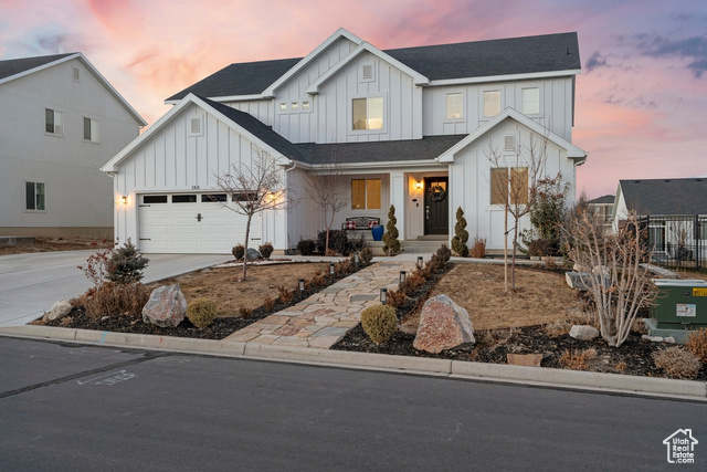 Modern farmhouse style home featuring a garage