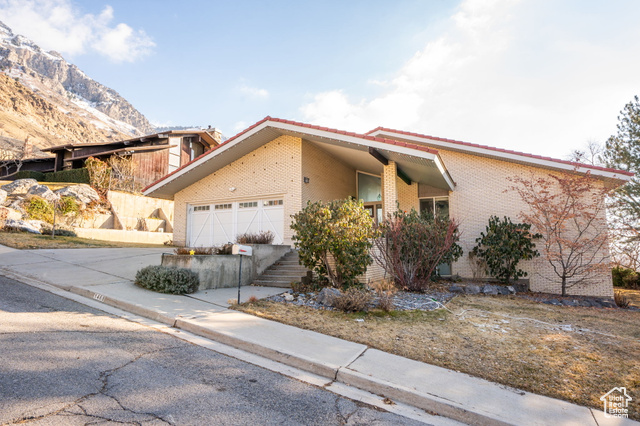 View of front of property featuring a mountain view and a garage