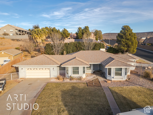 Ranch-style house with a garage and a front lawn