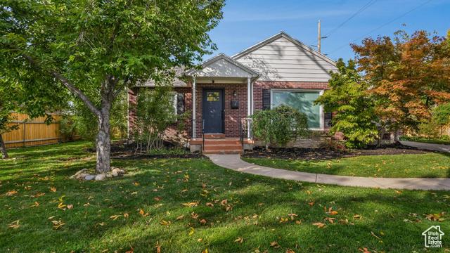 Bungalow-style house featuring a front lawn