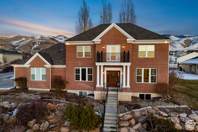 View of front facade with a balcony and a mountain view