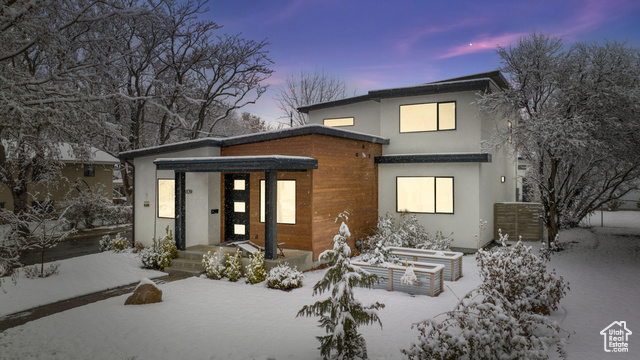 View of snow covered back of property