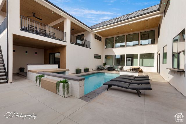 View of pool featuring an outdoor hangout area, a patio area, and ceiling fan