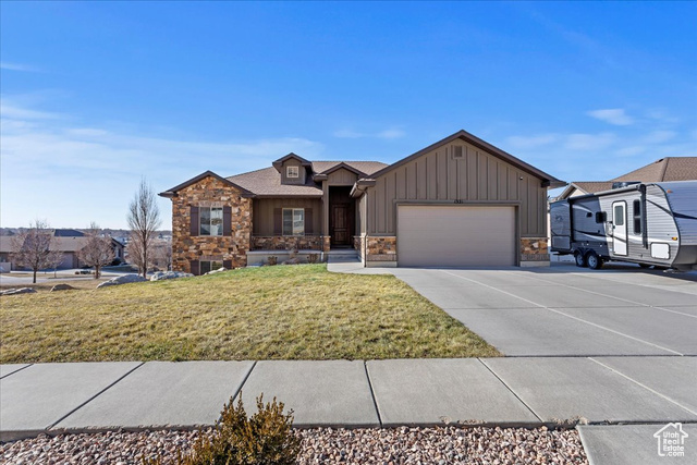 View of front of house featuring a garage and a front yard